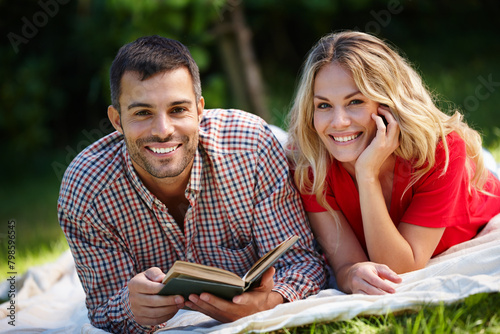 Portrait, happy couple and nature for reading book in park with green grass, together and picnic blanket. Woman, man and fiction story for hobby in outdoor with happiness, relaxing and romance