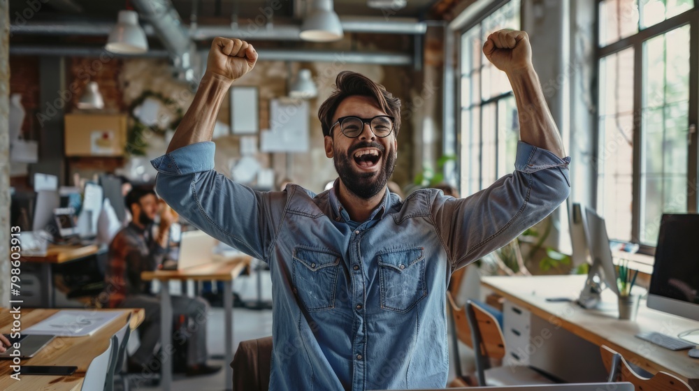 An entrepreneur in a startup office celebrating a successful funding round An entrepreneur in a startup office celebrating a successful funding round
