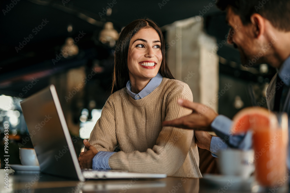 Shot of a young man and woman having a meeting in a cafe