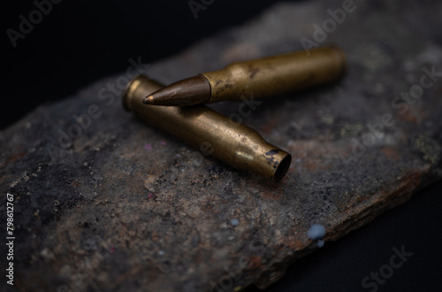 Two empty 7.62mm rounds laying on each other photo