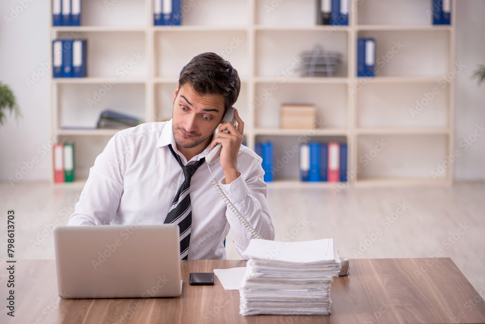 Young male employee working in the office Young male employee working in the office