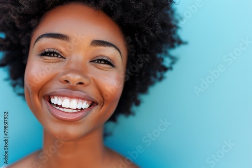 Close-up of smiling african woman in blue background