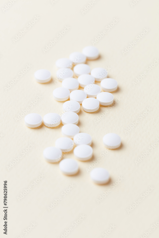 Biotin Tablets. Bright paper background. Close up.
