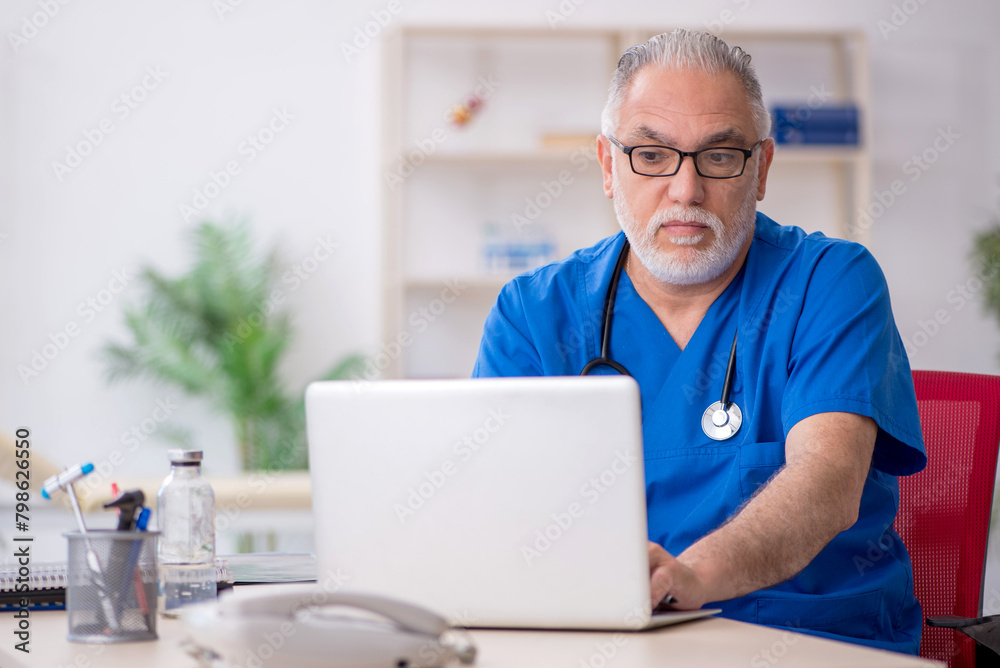 Old male doctor in telemedicine concept Old male doctor in telemedicine concept