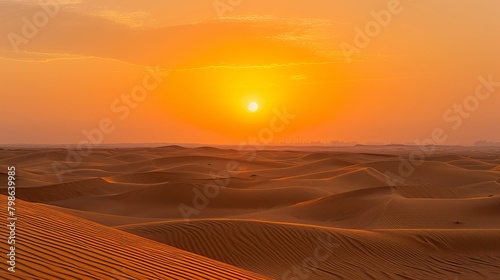The sun sets over the vast desert sands  casting golden hues across the horizon in Dubai  United Arab Emirates.
