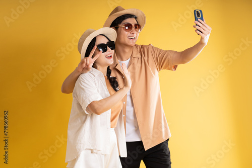 Portrait image of couple posing on yellow background, summer, travel