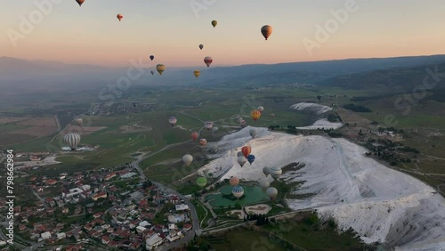 Hot air balloons and Natural travertine pools at sunrise in Pamukkale, 