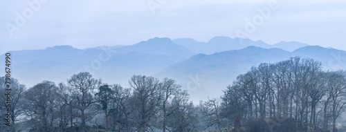 Stunning peaceful landscape image of misty Spring morning over Windermere in Lake District and distant misty peaks © veneratio