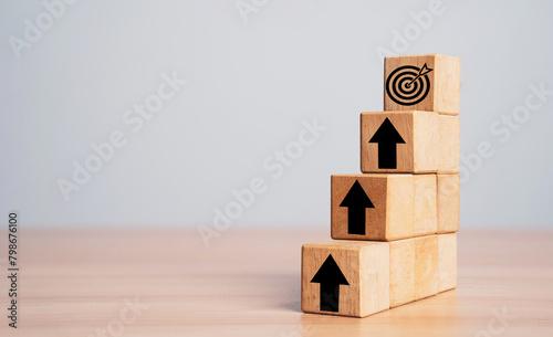 фотографія Dartboard and arrow on the top of  stairs with up arrow for enhance setup business objective target and goal concept