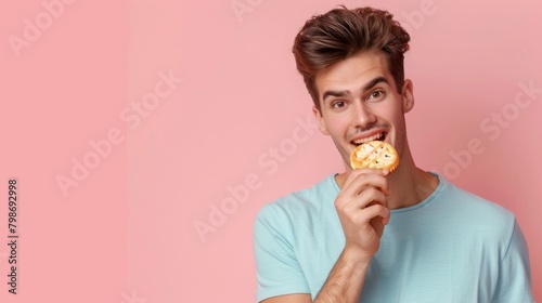 Man eat biscuit snack for tea time copy space isolated blue