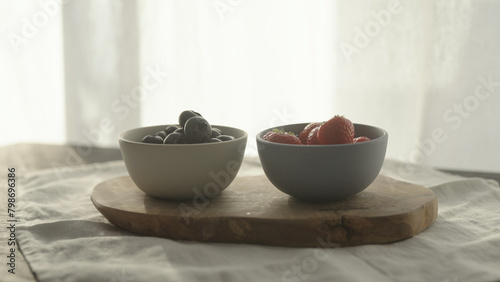 Wallpaper Mural fresh blueberries and strawberries in ceramic bowls with natural light Torontodigital.ca
