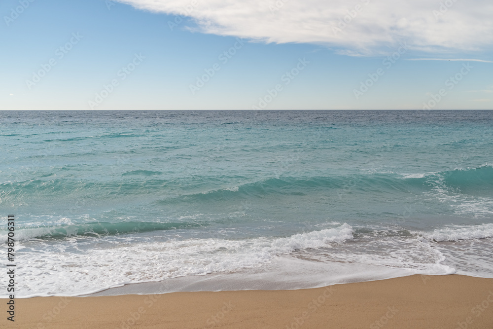 Empty sand beach on Mediterranean sea with horizon line vacation background