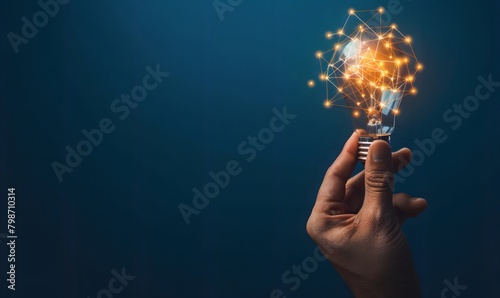 A hand holding a light bulb 