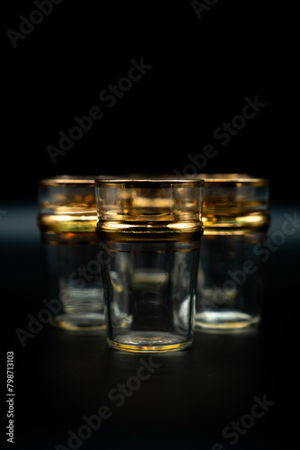 glasses with gold rings on black background 