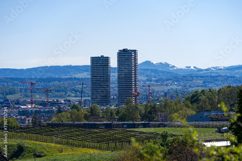 Scenic landscape with skyline of Stettbach and mountain panorama in the background at Swiss City of Z  rich on a sunny spring day. Photo taken April 27th  2024  Zurich  Switzerland.