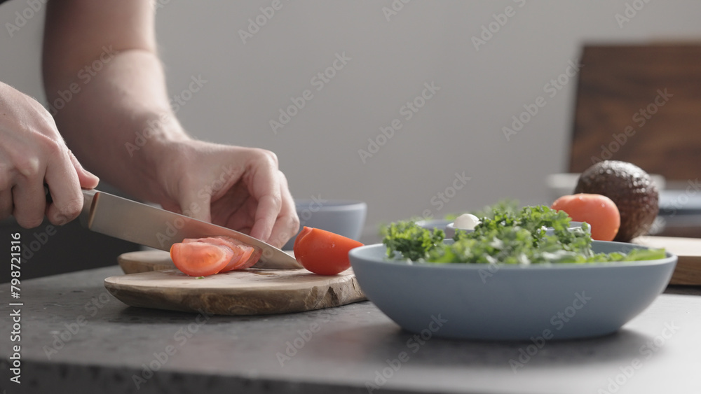 man make salad with kale, mozzarella, avocado and cherry tomatoes, cut cherry tomatoes man make salad with kale, mozzarella, avocado and cherry tomatoes, cut cherry tomatoes