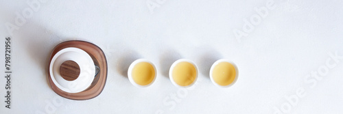 Asian tea concept banner with with white cups of tea and teapot