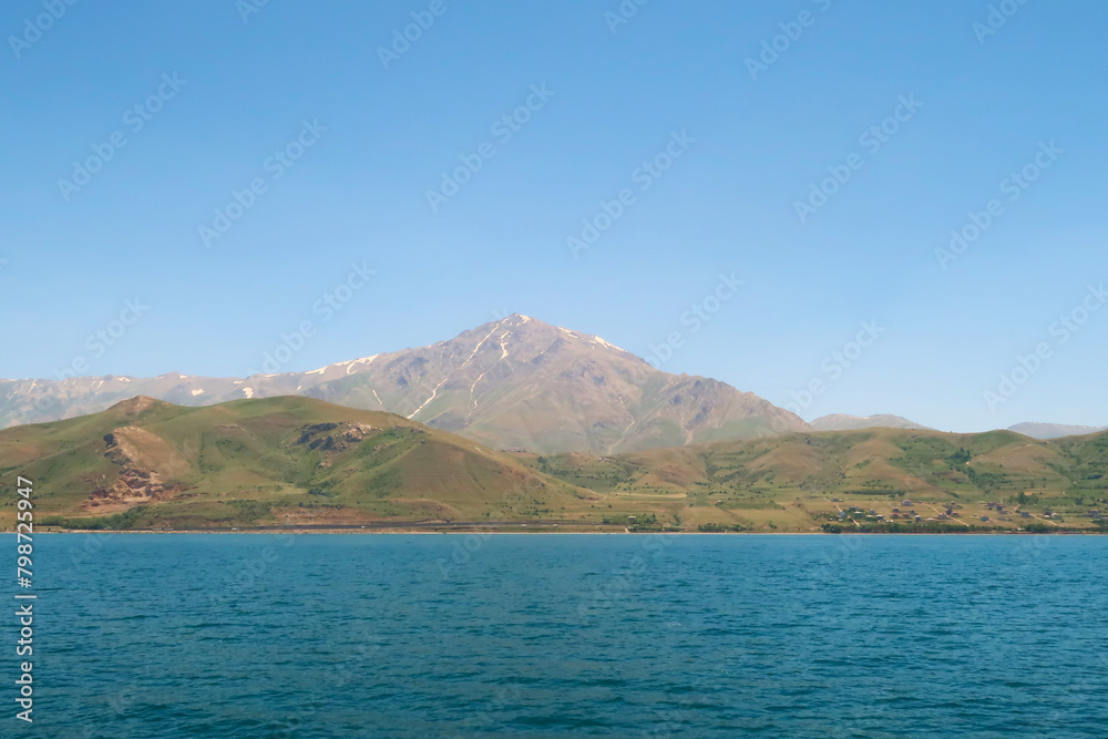Mount Artos seen from Lake Van, Van Gölü, the intense blue color of the water in the foreground and the dormant volcano in the background, Van, Turkey