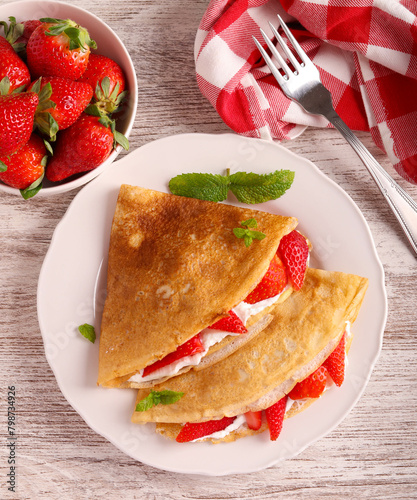 Crepes with sour cream and strawberry filling