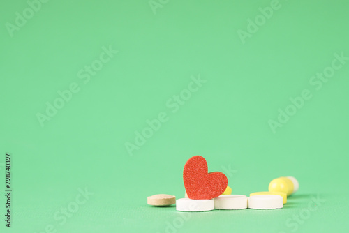 Heart and pills, a photo symbolizing medical treatment of the heart. Help with heart pain
