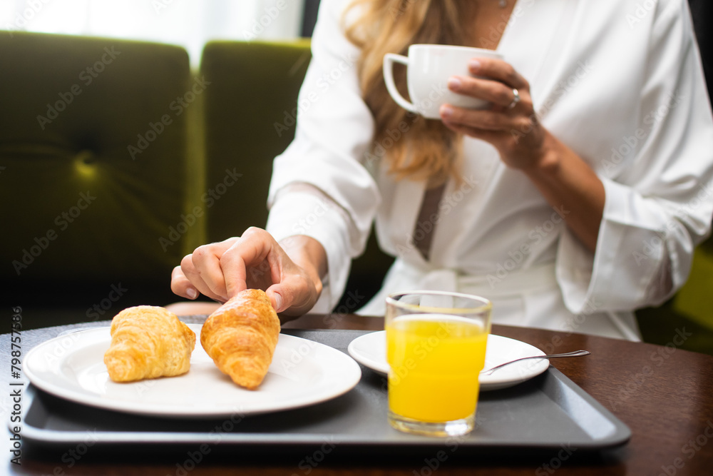 Morning refreshment: woman enjoying breakfast