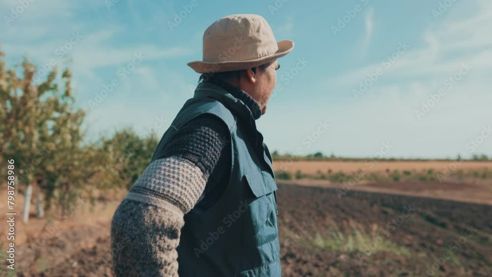 Seasoned Wisdom Senior Farmer Examining Soil in Autumn Harvest