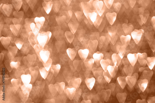 Defocused abstract hearts on peach color background