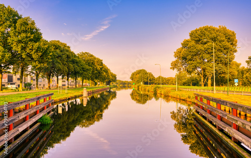Reflection of the blue sky in the still waters of the Wilhelminakanaal canal in The Netherlands. photo