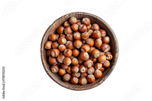 Roasted hazelnuts in wooden bowl. Crisp toasted nuts of the hazel. Shelled whole seeds of cobnuts or filbert nuts isolated on white background.