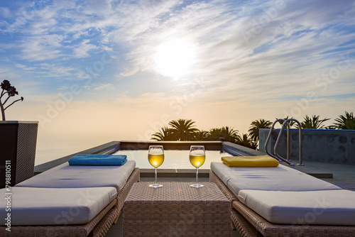 Two wine glasses at swimming pool at sunset, La Palma, Canary Islands, Spain, Europe.