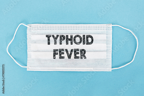 Tableau sur toile A protective face mask with the words Typhoid Fever printed on it, indicating a focus on medical precautions and awareness