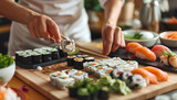 Woman preparing sushi rolls at table
