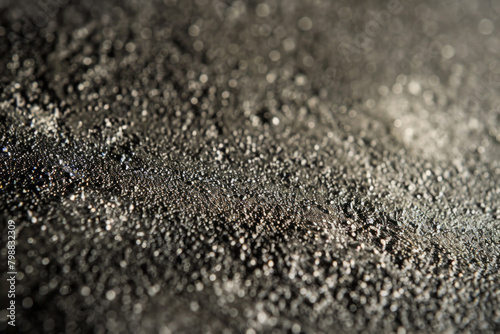 Rough and grainy texture of sandpaper, showcasing its abrasive surface and tactile feel. Sandpaper textures offer a gritty and industrial backdrop