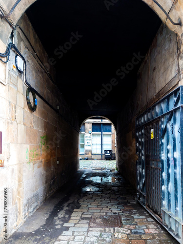 A tunnel leading to a courtyard