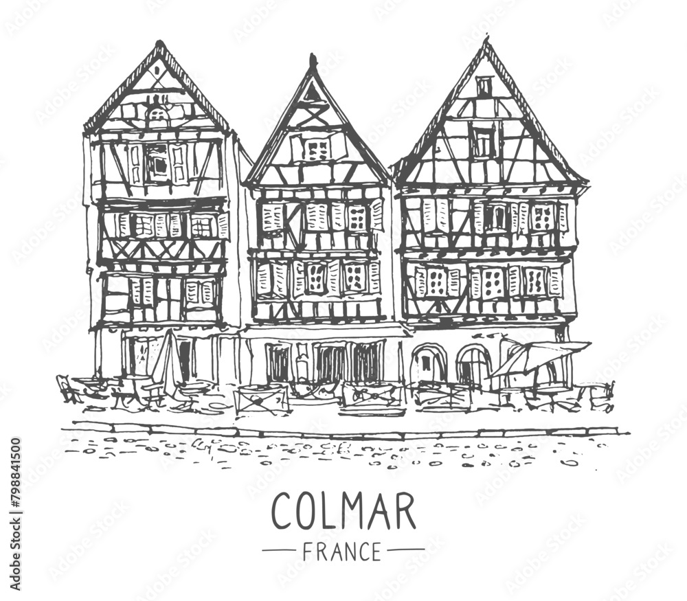 Vector travel sketch of Colmar, France. Hand drawing of the old town and a street cafe. French houses line art. Hand drawn travel postcard. Urban sketch in black color isolated on a white background.