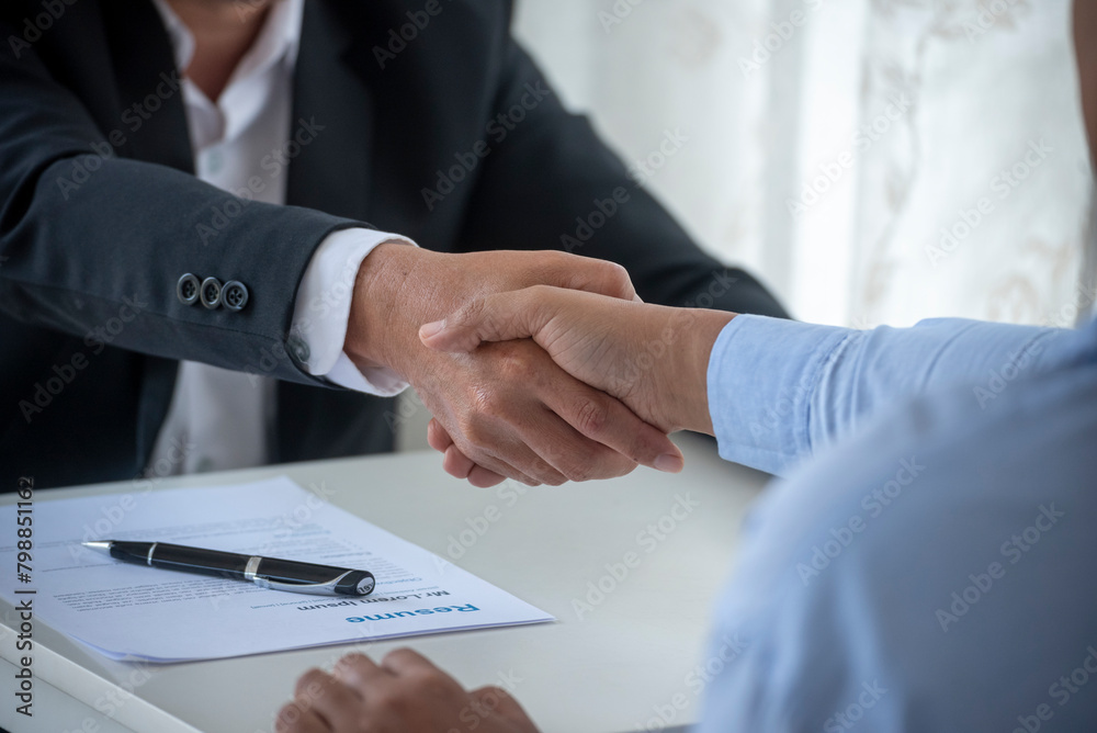 Obraz premium Close up hands Team Business Partners shaking hands together to Greeting Start up new project. Shakehand Teamwork Partnership office desk. Businessman partners handshake together. Business concept