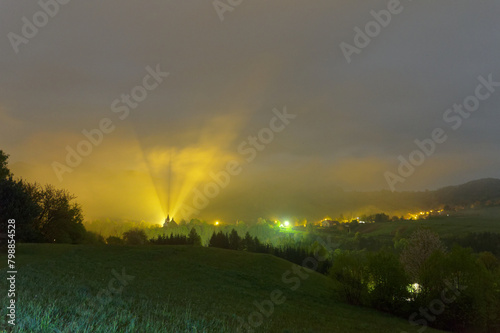 Fototapeta Naklejka Na Ścianę i Meble -  View of the church in the fog, illuminated by light in the Bieszczady mountains, Terka town.