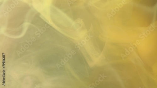 Close-up view capturing the delicate twirl of smoke above a bed of vibrant yellow textures. (ID: 798862197)