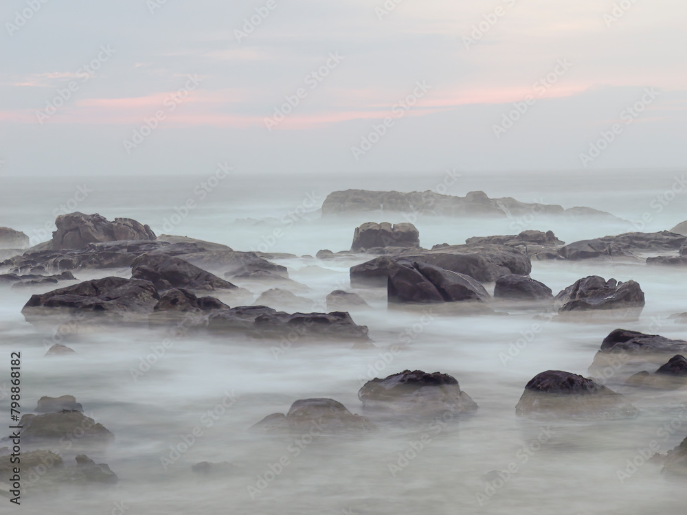 Rocky coast at misty dusk