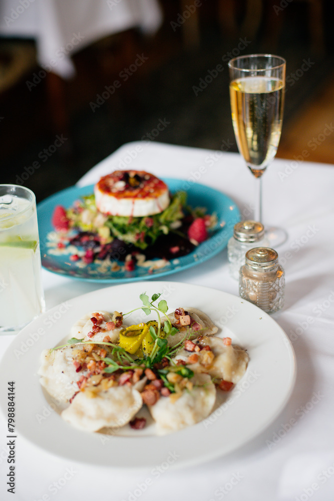 dumplings with meat with microgreens with drinks and salad with goat cheese dumplings with meat with microgreens with drinks and salad with goat cheese