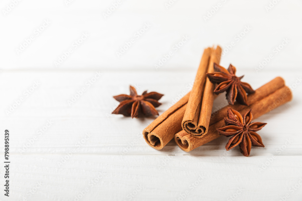 Cinnamon sticks and anise on a textured background. Cinnamon roll and star anise. Spicy spice for baking, desserts and drinks. Fragrant ground cinnamon.Place for text. copy space. Cinnamon sticks and anise on a textured background. Cinnamon roll and star anise. Spicy spice for baking, desserts and drinks. Fragrant ground cinnamon.Place for text. copy space.
