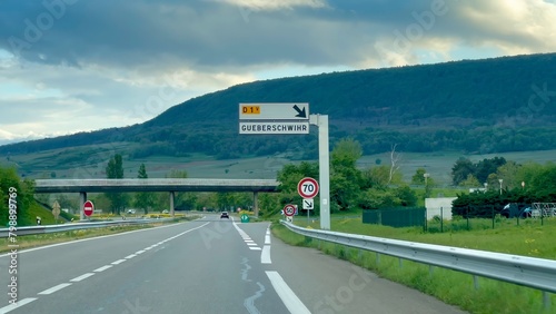 Approaching Gueberschwihr: Verdant Vistas along D83 in Haut-Rhin, Alsace, France photo