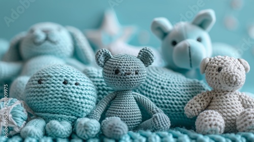 Delicate assortment of knitted infant toys on a serene cyan backdrop suitable for a tranquil baby atmosphere