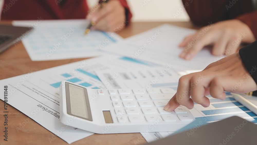 Financial analysts analyze business financial reports on a digital tablet planning investment project during a discussion at a meeting of corporate showing the results of their successful teamwork. Financial analysts analyze business financial reports on a digital tablet planning investment project during a discussion at a meeting of corporate showing the results of their successful teamwork.