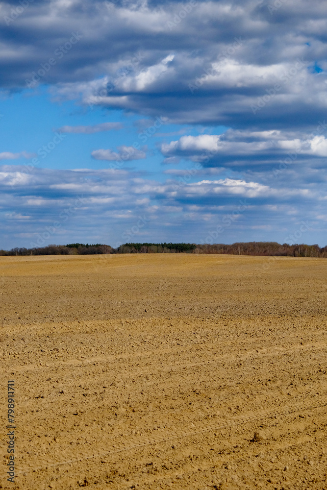 A clear day over freshly tilled agricultural land. A clear day over freshly tilled agricultural land.
