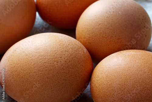 Freshly laid brown eggs with distinct textures, emphasizing farm-to-table and natural food movements.