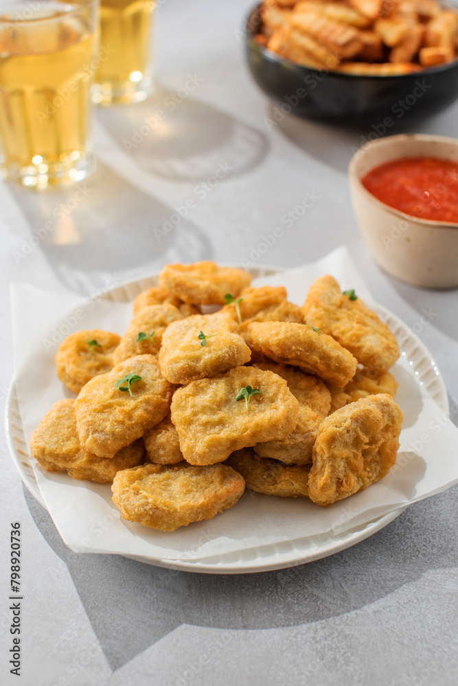 There is a plate of crispy chicken nuggets on the table. Fast food, fast food restaurant. There is a plate of crispy chicken nuggets on the table. Fast food, fast food restaurant.