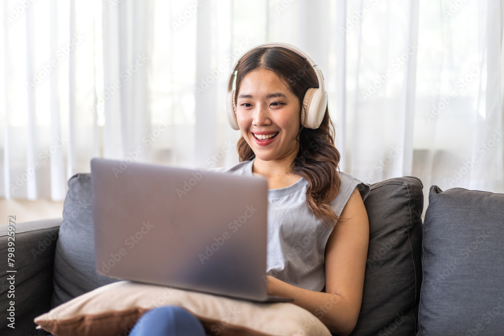 Young smiling asian woman happy relax use laptop conference work,learning, education, shopping, study online, webinar, online marketing, business, blog, digital internet advertising at home Young smiling asian woman happy relax use laptop conference work,learning, education, shopping, study online, webinar, online marketing, business, blog, digital internet advertising at home