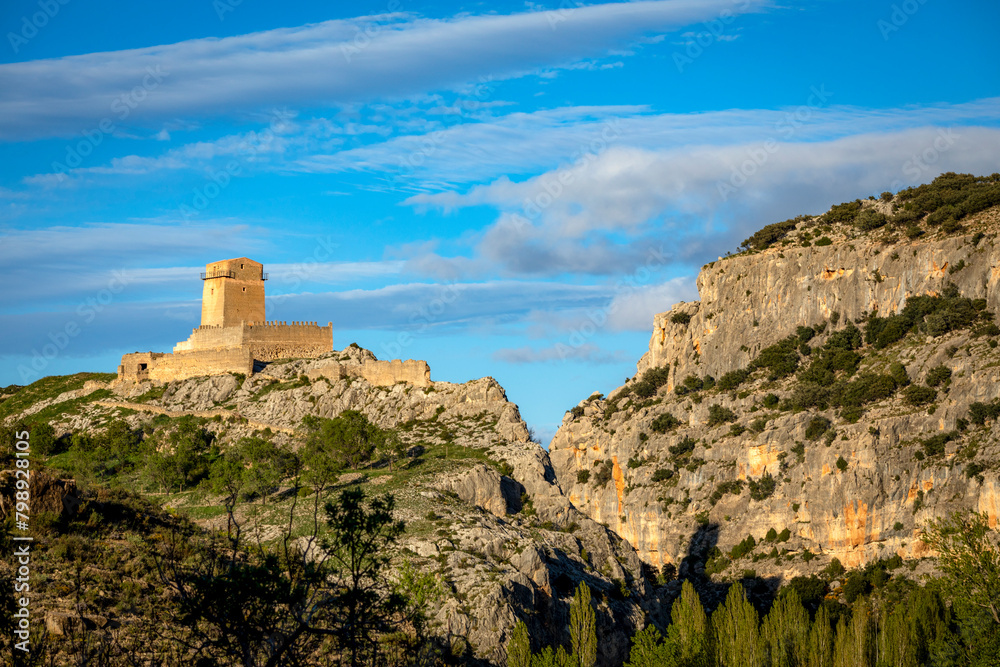 View from the distance of the medieval Taibilla castle in Nerpio, Albacete, Castilla la Mancha, Spain in a rocky setting at sunset