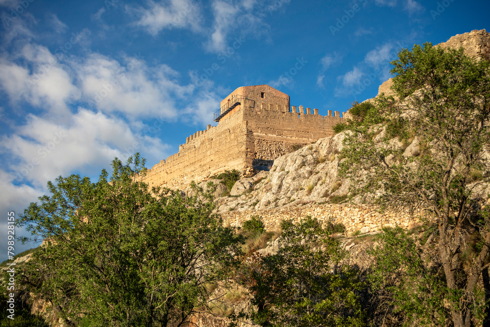 View of the crenellated walls
 on the rise of the medieval castle of Taibilla in Nerpio, Albacete, Castilla la Mancha, Spain in a rocky environment